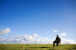 man sitting in field