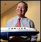 Glenn Tilton holding model airplane.